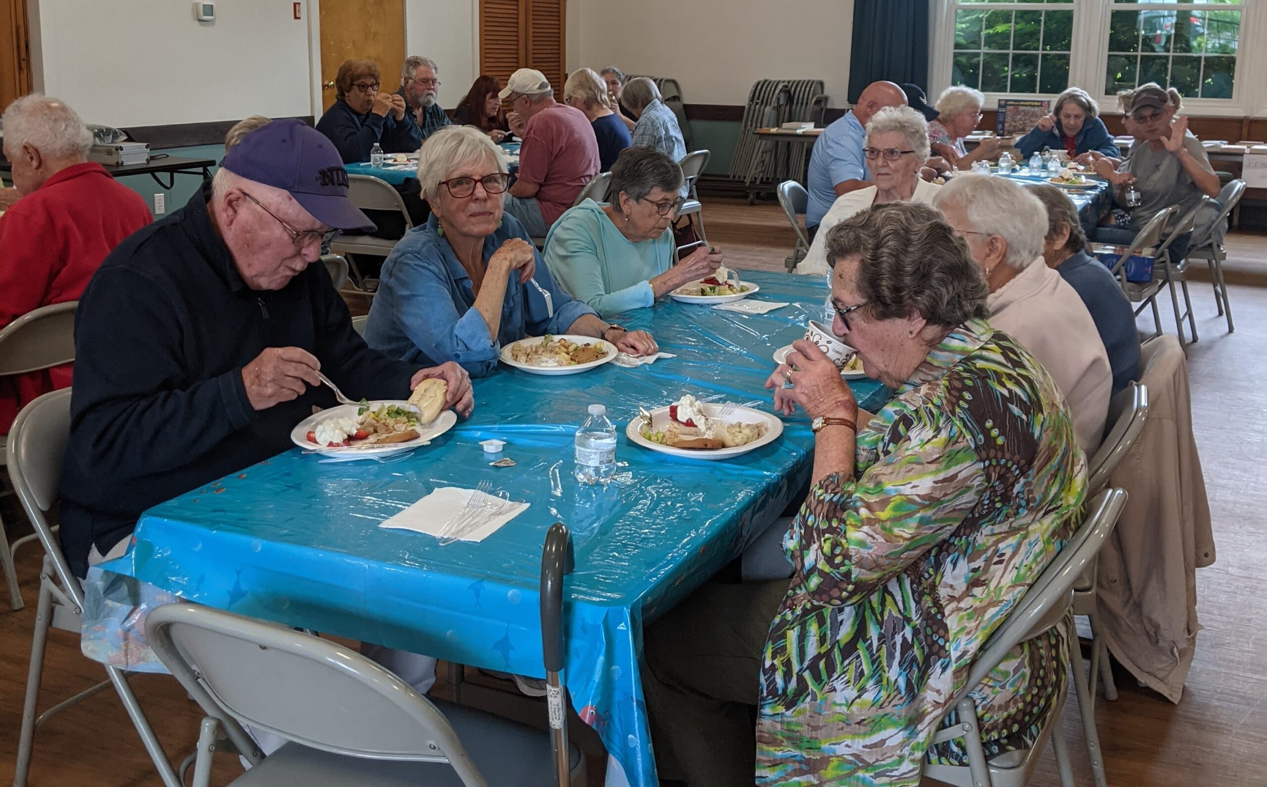 Older folks eating at a table